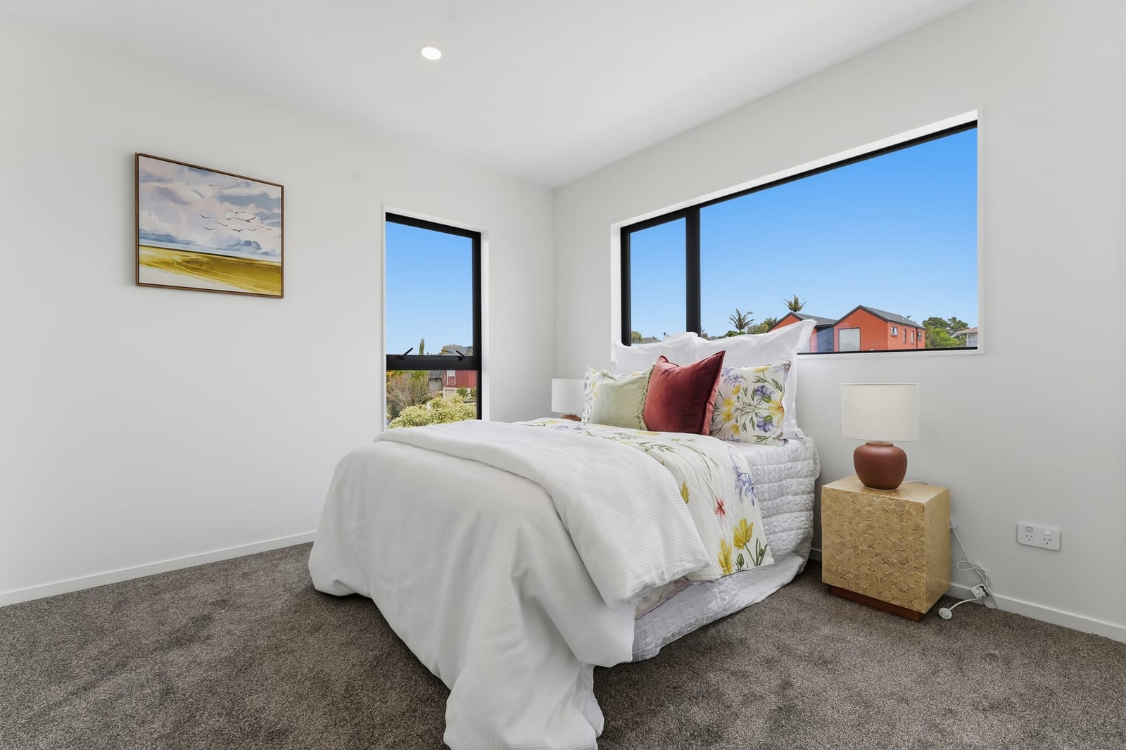 Bedroom with two windows and floral bedding