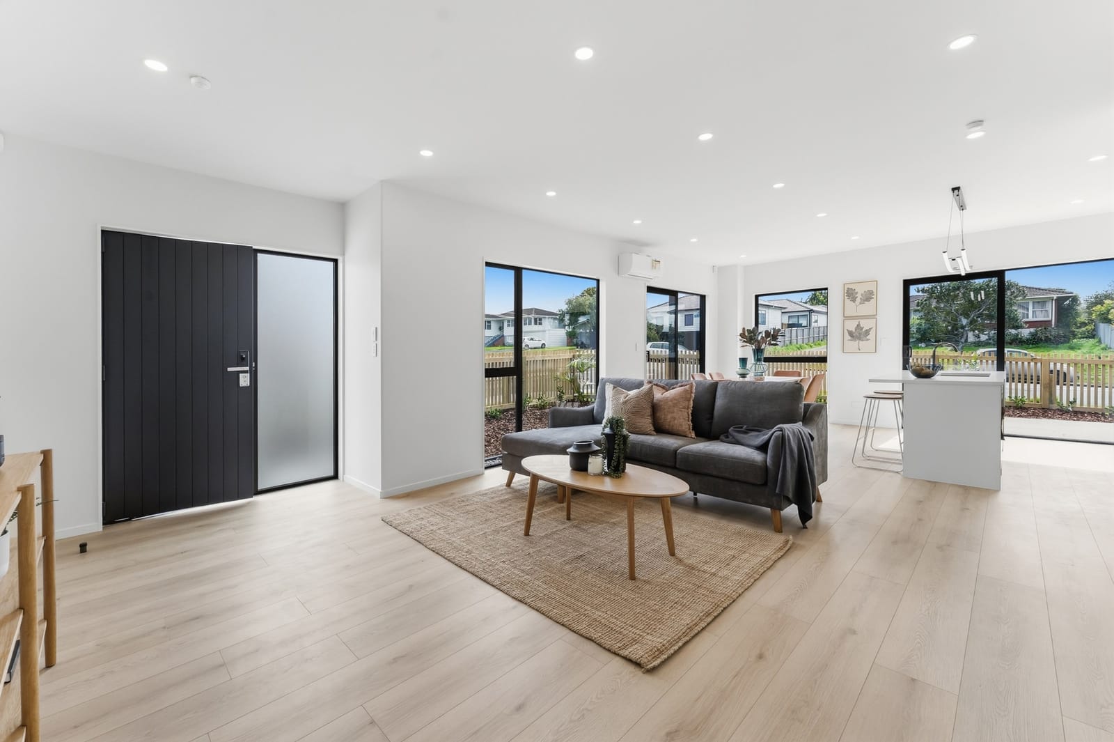Living area inside the front door, with the kitchen island and dining beyond