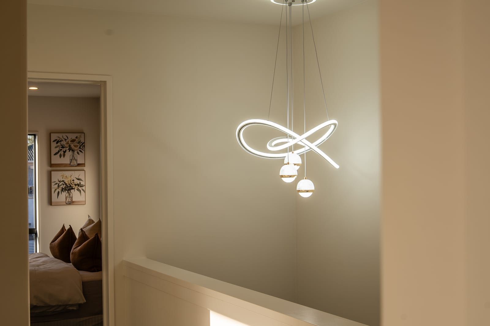 A sculptural pendant light hanging above the stairwell